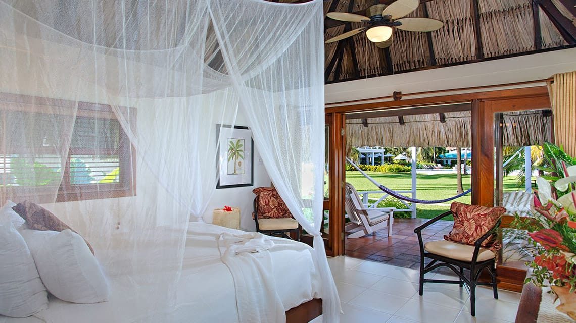Bedroom in Casita with thatched roof at Victoria House Resort and Spa, Belize