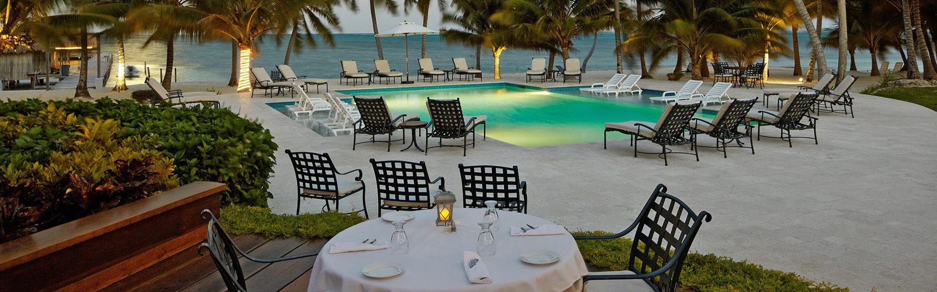 Dining table poolside at Victoria House Resort and Spa, Belize