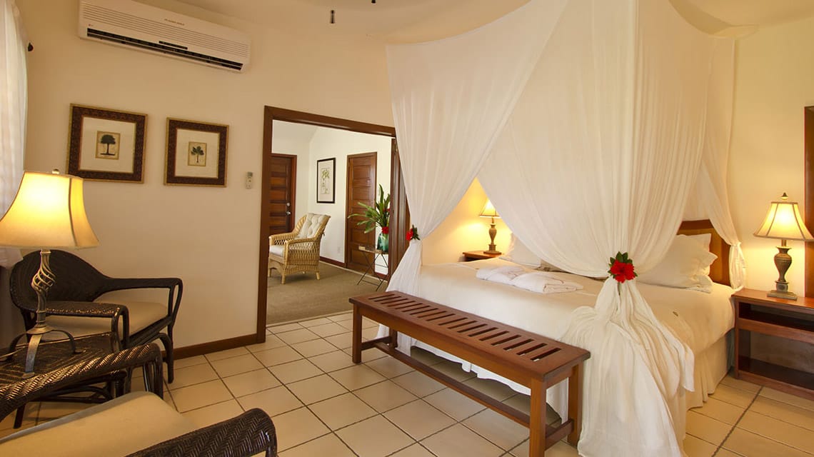 Coral & Hibiscus Suite bedroom at Victoria House Resort and Spa